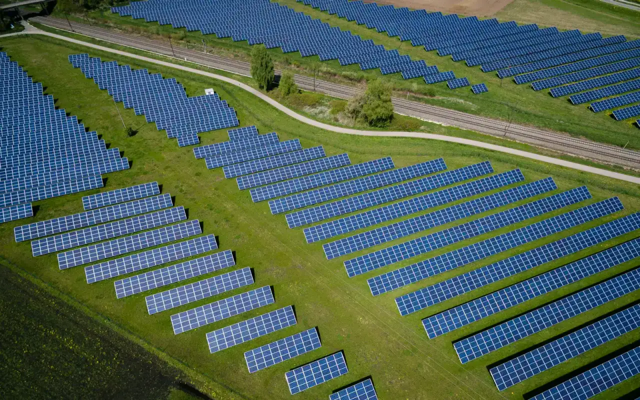 Aerial view of solar panel rows across open fields